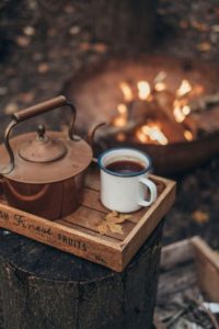 Warming cup of coffee in the winter garden